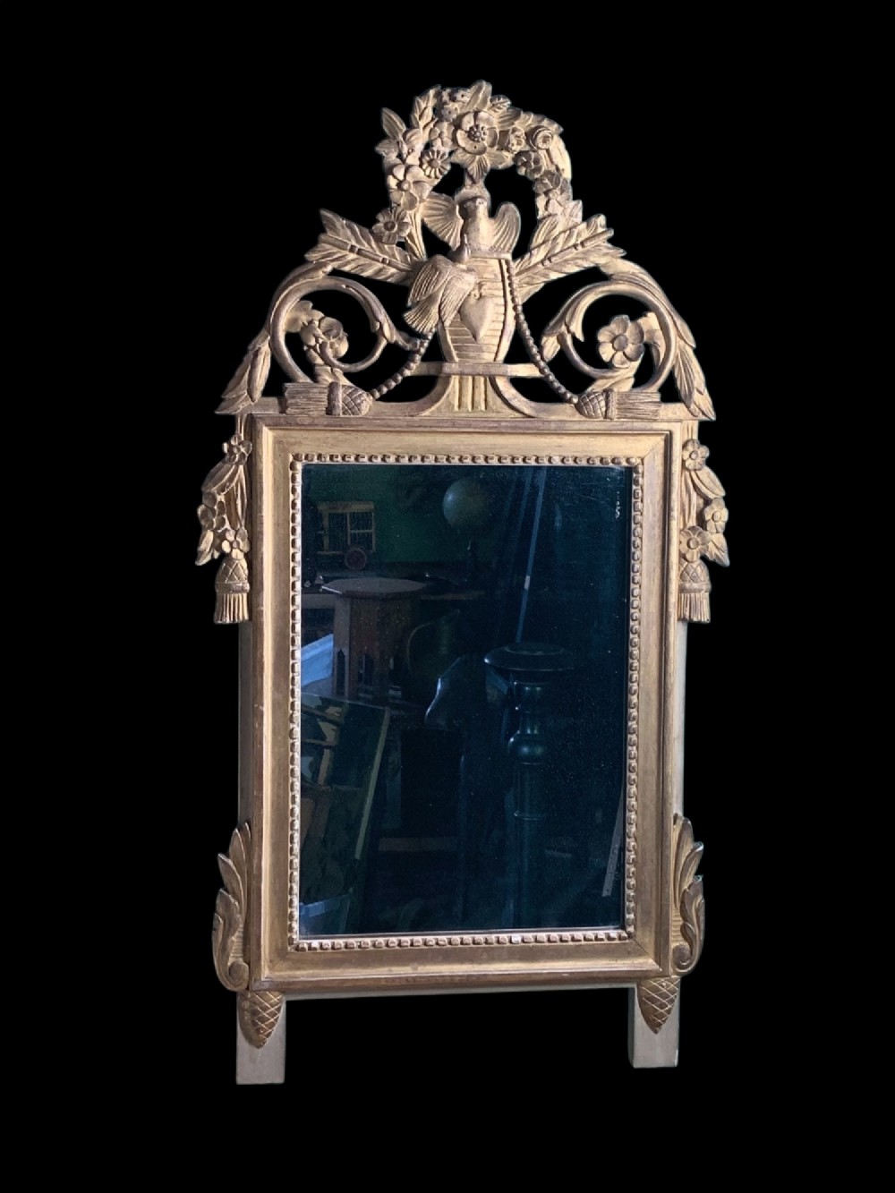 An 18th-century French giltwood marriage mirror with an ornate carved crest featuring doves, floral garlands, and a rectangular beaded mirror frame. View II
