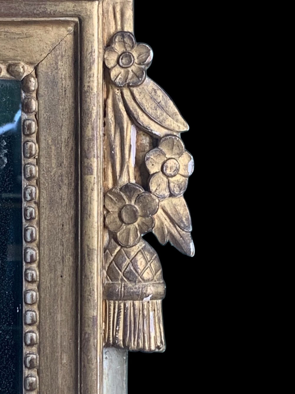 An 18th-century French giltwood marriage mirror with an ornate carved crest featuring doves, floral garlands, and a rectangular beaded mirror frame. View VII