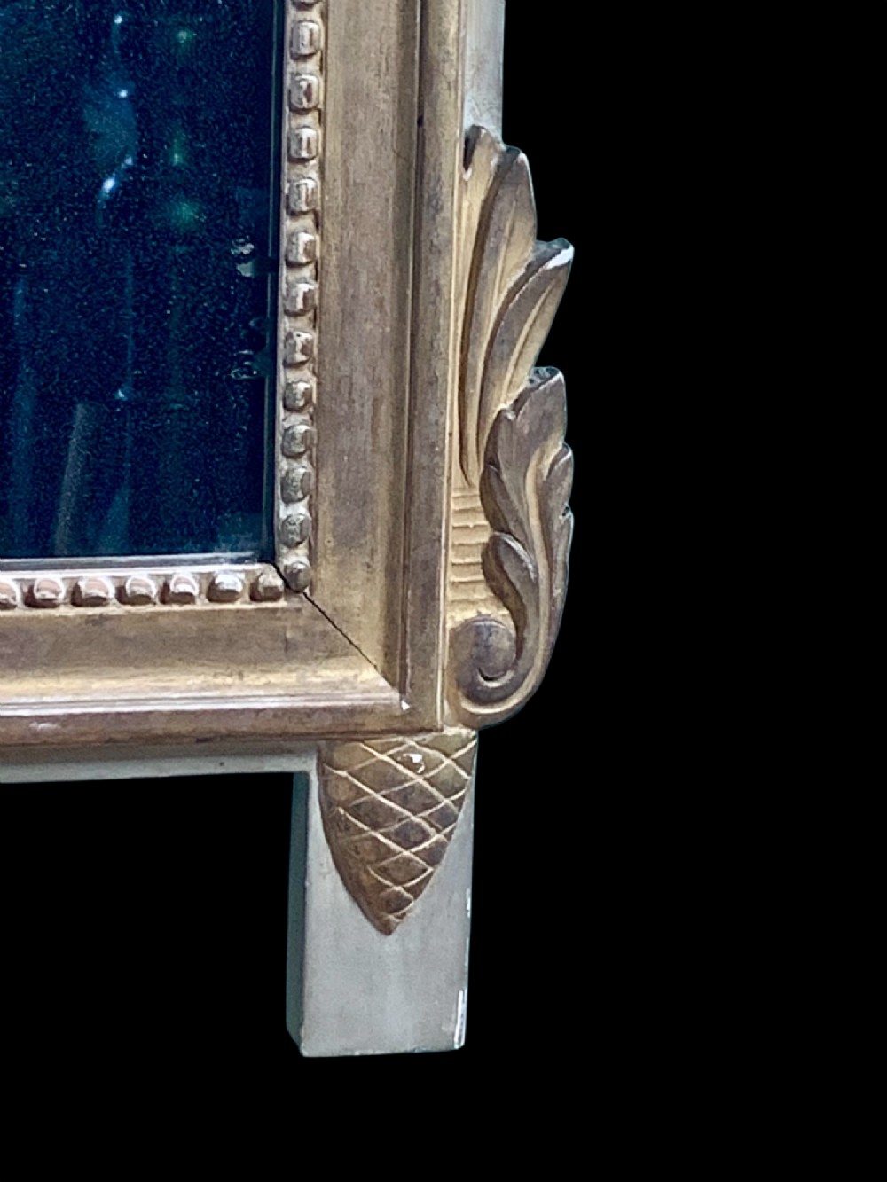 An 18th-century French giltwood marriage mirror with an ornate carved crest featuring doves, floral garlands, and a rectangular beaded mirror frame. View VIII