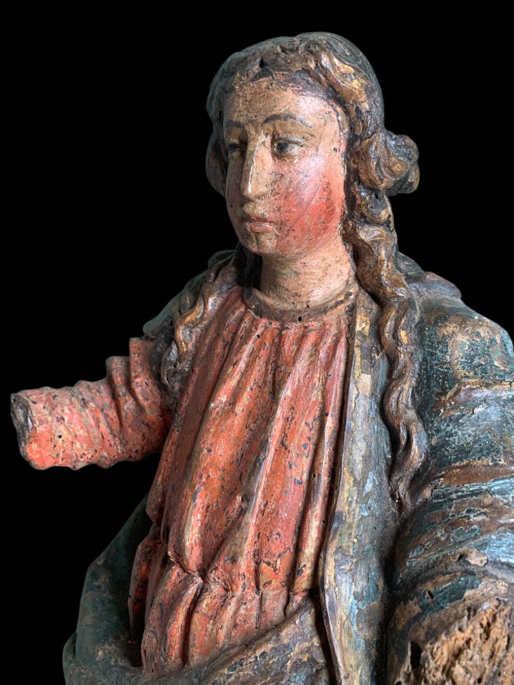 An eighteenth-century carved wood figure of a saint featuring red and blue polychrome paint, set upon a rectangular wooden base. View III