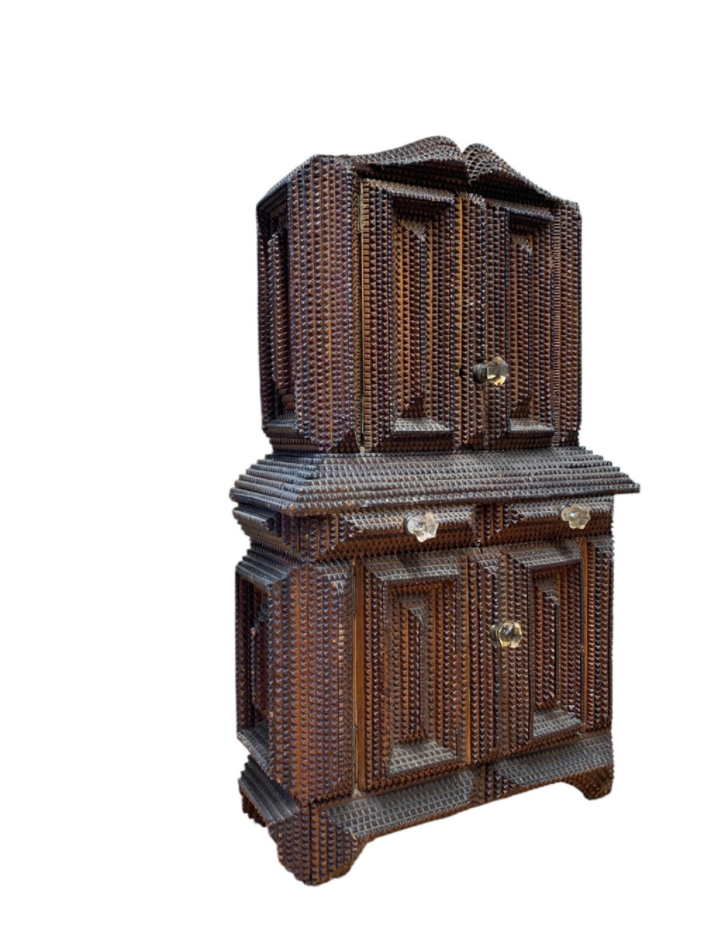 A miniature dark wood tramp art cabinet featuring layered notch-carved geometric borders, double upper doors, and small glass knobs. View VII