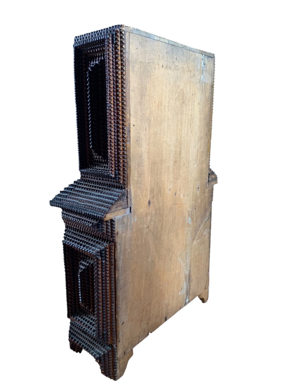 A miniature dark wood tramp art cabinet featuring layered notch-carved geometric borders, double upper doors, and small glass knobs. View VIII