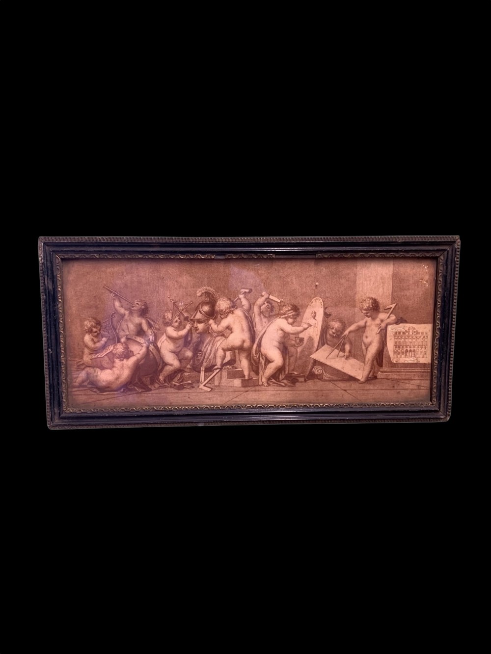 A horizontal monochrome 18th-century style framed engraving depicting classical putti engaged in artistic and architectural pursuits.