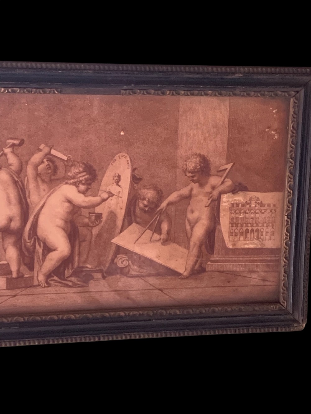 A horizontal monochrome 18th-century style framed engraving depicting classical putti engaged in artistic and architectural pursuits. View III