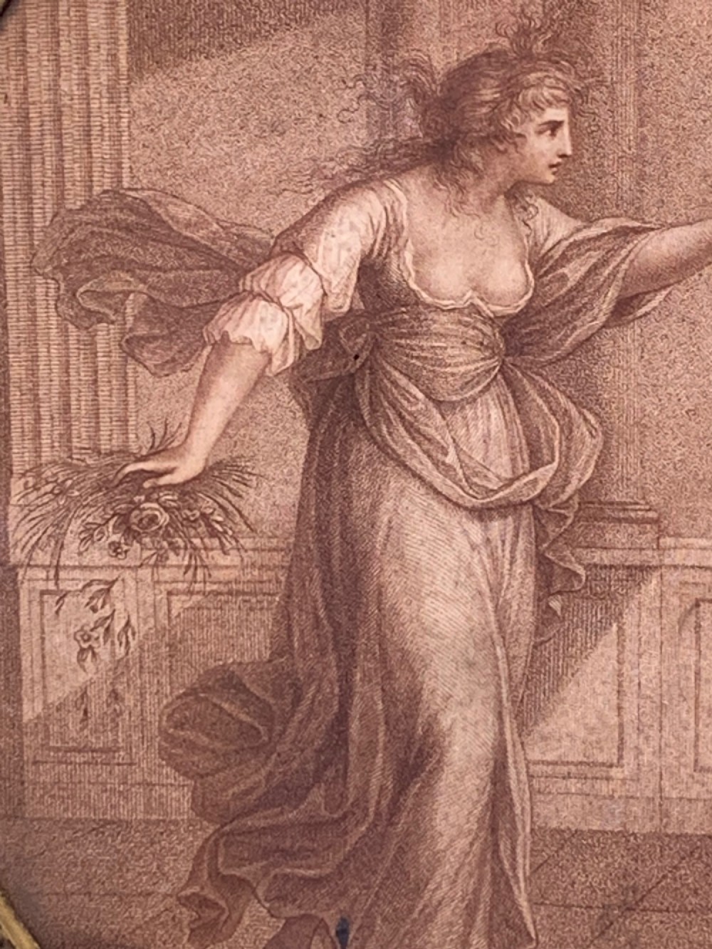 An 18th-century oval stipple engraving depicting a draped classical figure with foliage, housed in a beaded giltwood frame. View V