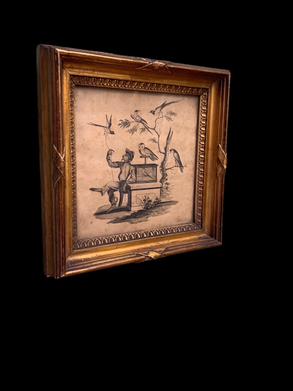 An 18th-century monochrome etching featuring a clothed monkey seated beside a birdcage surrounded by birds, enclosed in an ornate gold leaf frame. View II