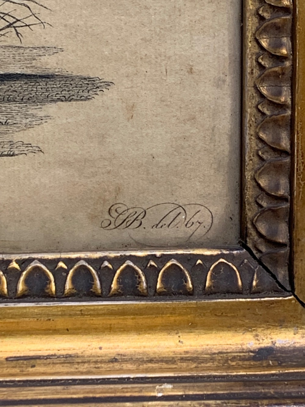An 18th-century monochrome etching featuring a clothed monkey seated beside a birdcage surrounded by birds, enclosed in an ornate gold leaf frame. View V