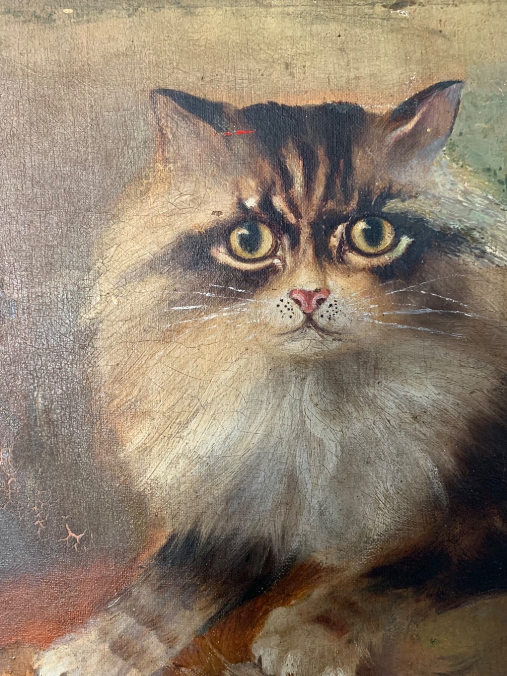 A 19th-century naive school oil painting depicting a fluffy longhaired cat holding a small bird, set beside pale cream flowers against a warm brown background. View III