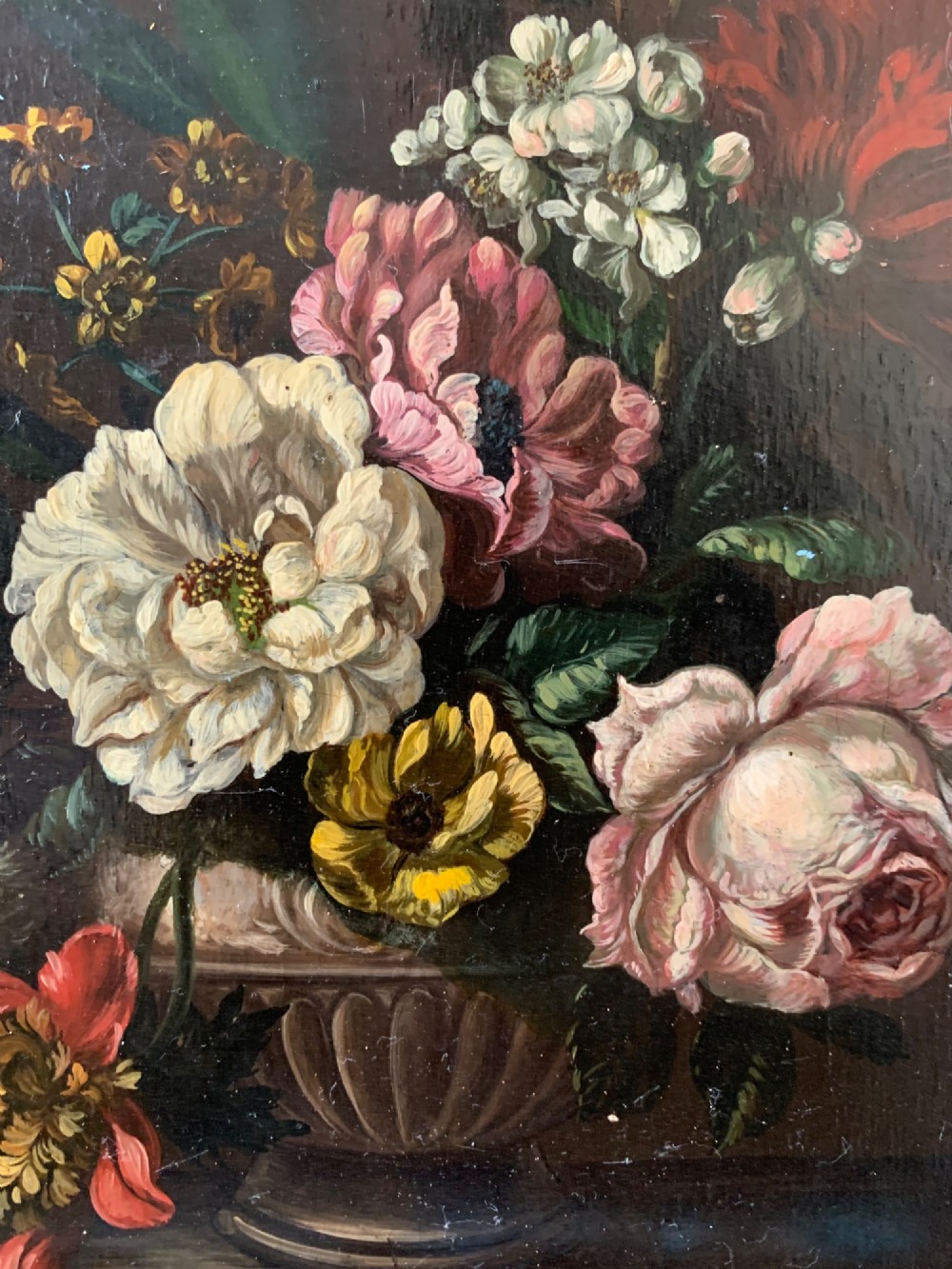 A framed Dutch School style oil painting on wood panel featuring a varied arrangement of flowers in a fluted urn set against a dark background. View VI