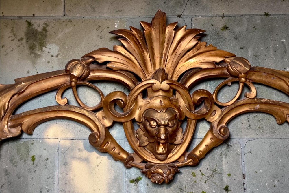 A set of three carved gold giltwood wall fragments decorated with central mascaron faces and scrolling acanthus leaves. View VIII