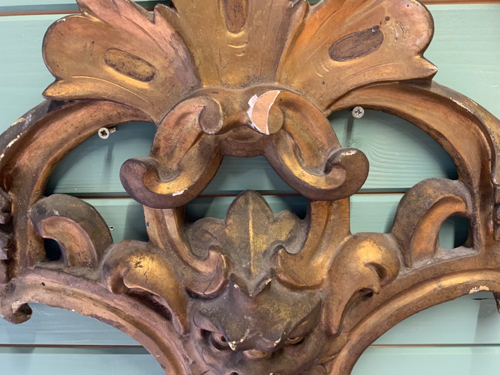 A set of three carved gold giltwood wall fragments decorated with central mascaron faces and scrolling acanthus leaves. View X