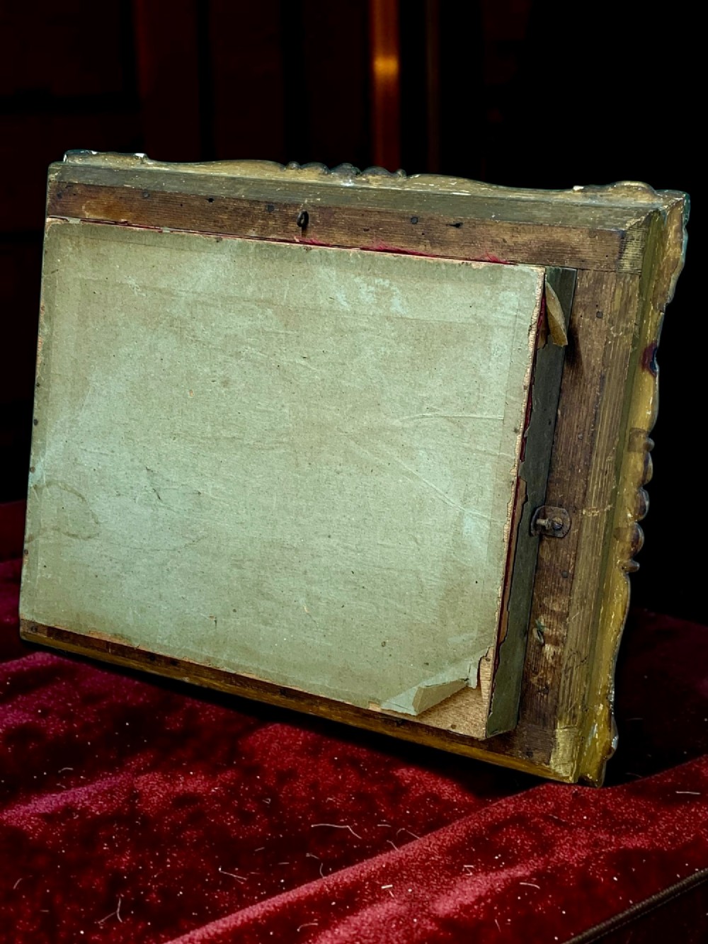 An antique gilt-framed shadow box diorama depicting four miniature costumed theatrical figures against a crimson draped fabric backdrop. View XI