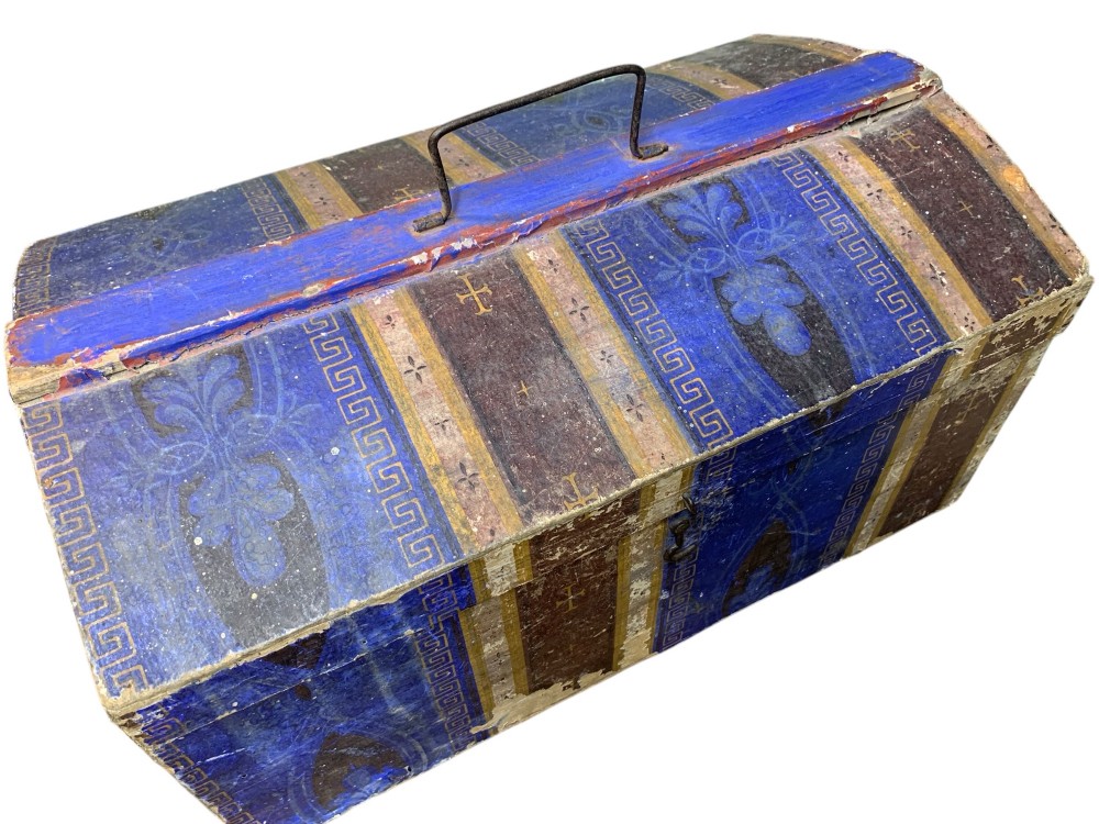 An 18th-century domed-top wooden dowry box covered in patterned blue and brown block-printed paper with iron hardware. View III