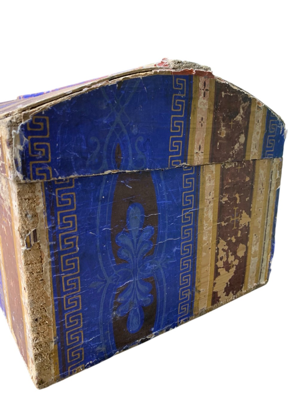 An 18th-century domed-top wooden dowry box covered in patterned blue and brown block-printed paper with iron hardware. View V