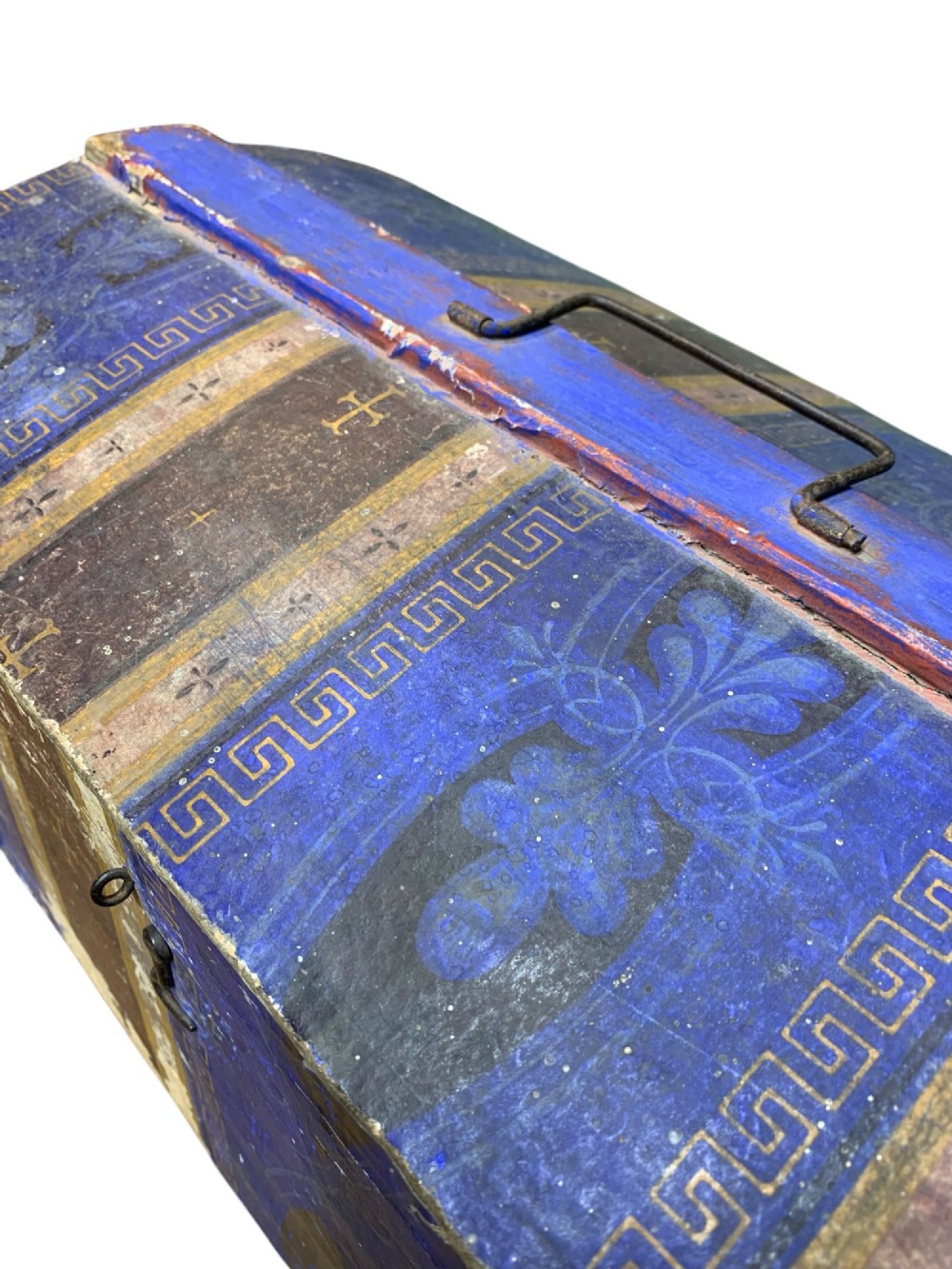 An 18th-century domed-top wooden dowry box covered in patterned blue and brown block-printed paper with iron hardware. View VI