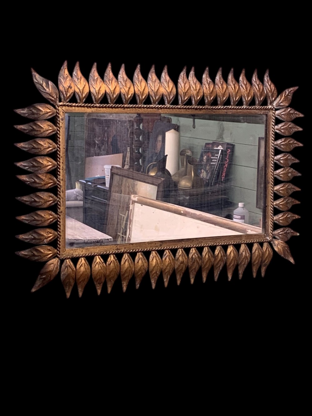 A rectangular horizontal landscape mirror framed in aged gilt metal surrounded by radiating leaf-shaped motifs and a inner rope-twist border. View II