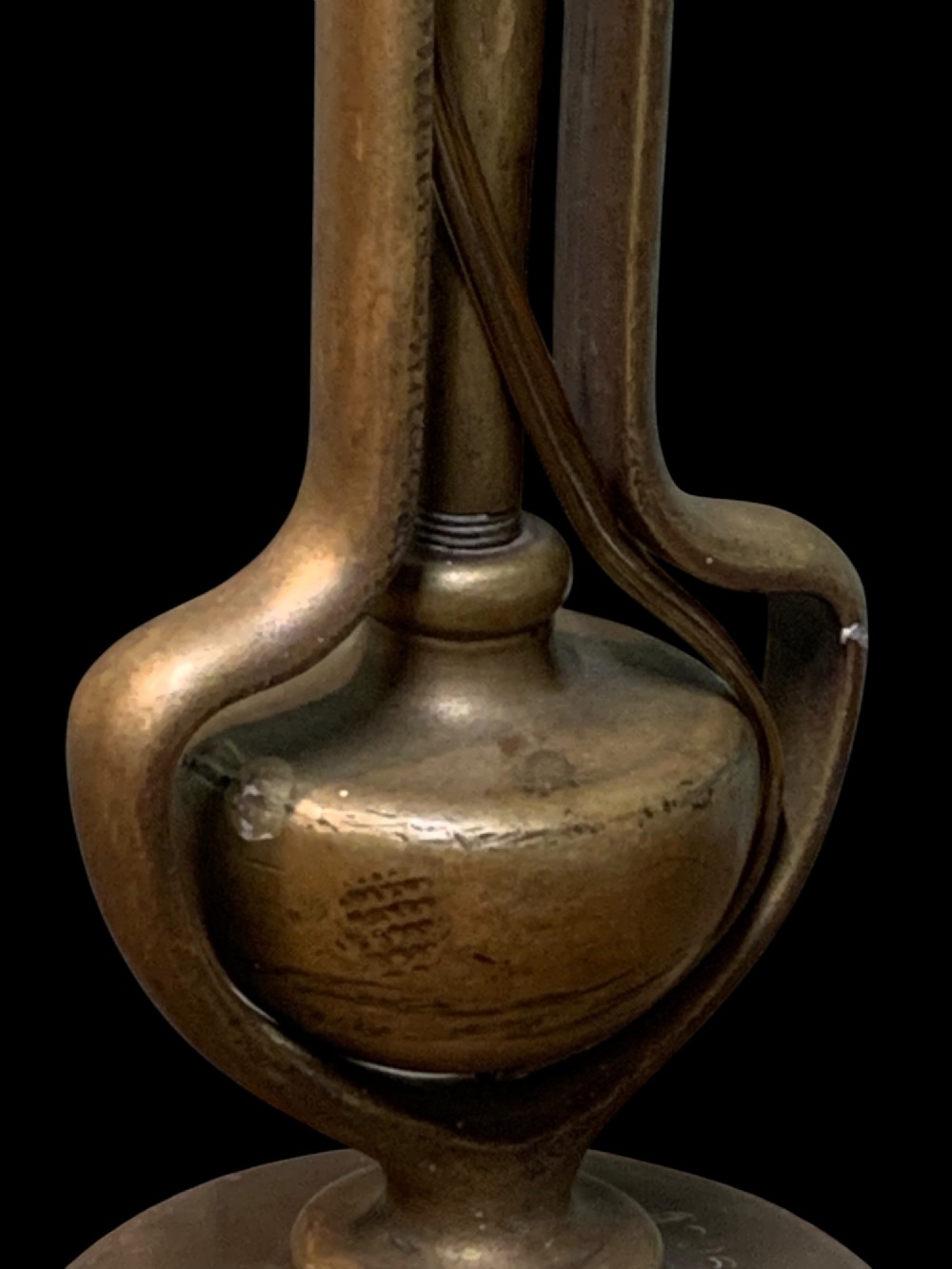 An early twentieth-century patinated brass gimballed ship table lamp featuring a weighted circular base and articulated swivel mechanism. View V