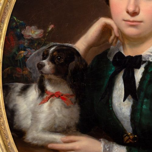 fig 4. An oval-framed antique oil painting depicting a seated young woman in a green dress holding a small pet dog.