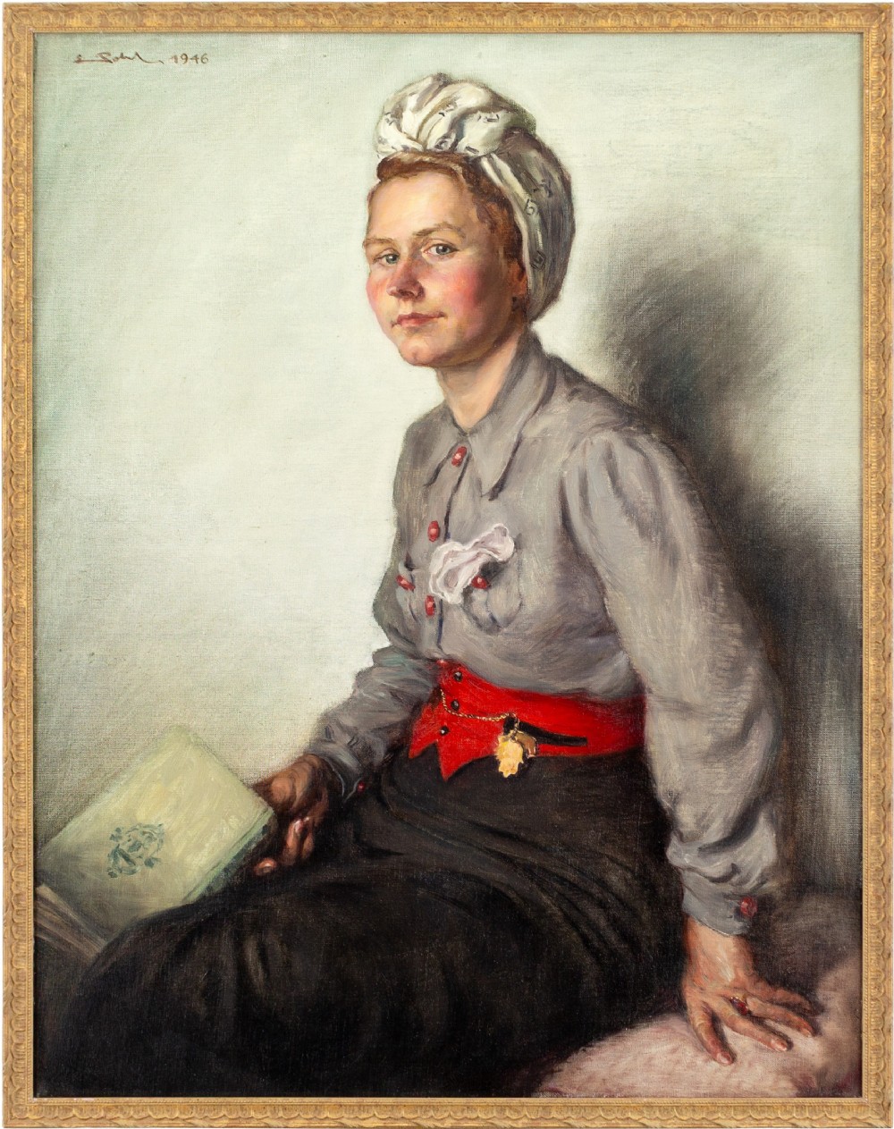 A mid-century oil painting on canvas depicting a seated woman in a grey blouse, patterned headscarf, and red waistband holding a green book, set within a thin gilt frame.
