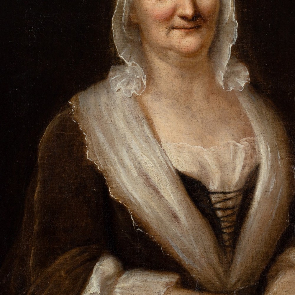 An eighteenth-century oil portrait of an elderly woman wearing a lace bonnet and dark gown, set within a black and gilt wooden frame. View IV