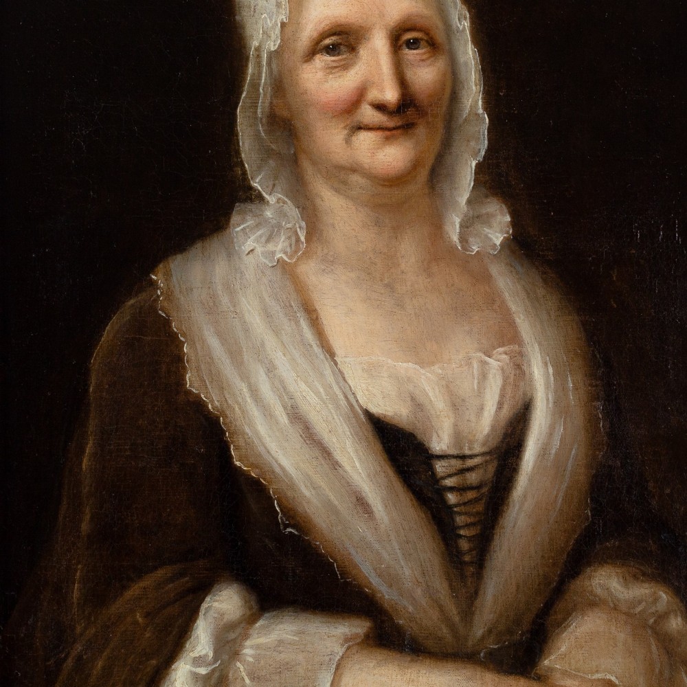 An eighteenth-century oil portrait of an elderly woman wearing a lace bonnet and dark gown, set within a black and gilt wooden frame. View V