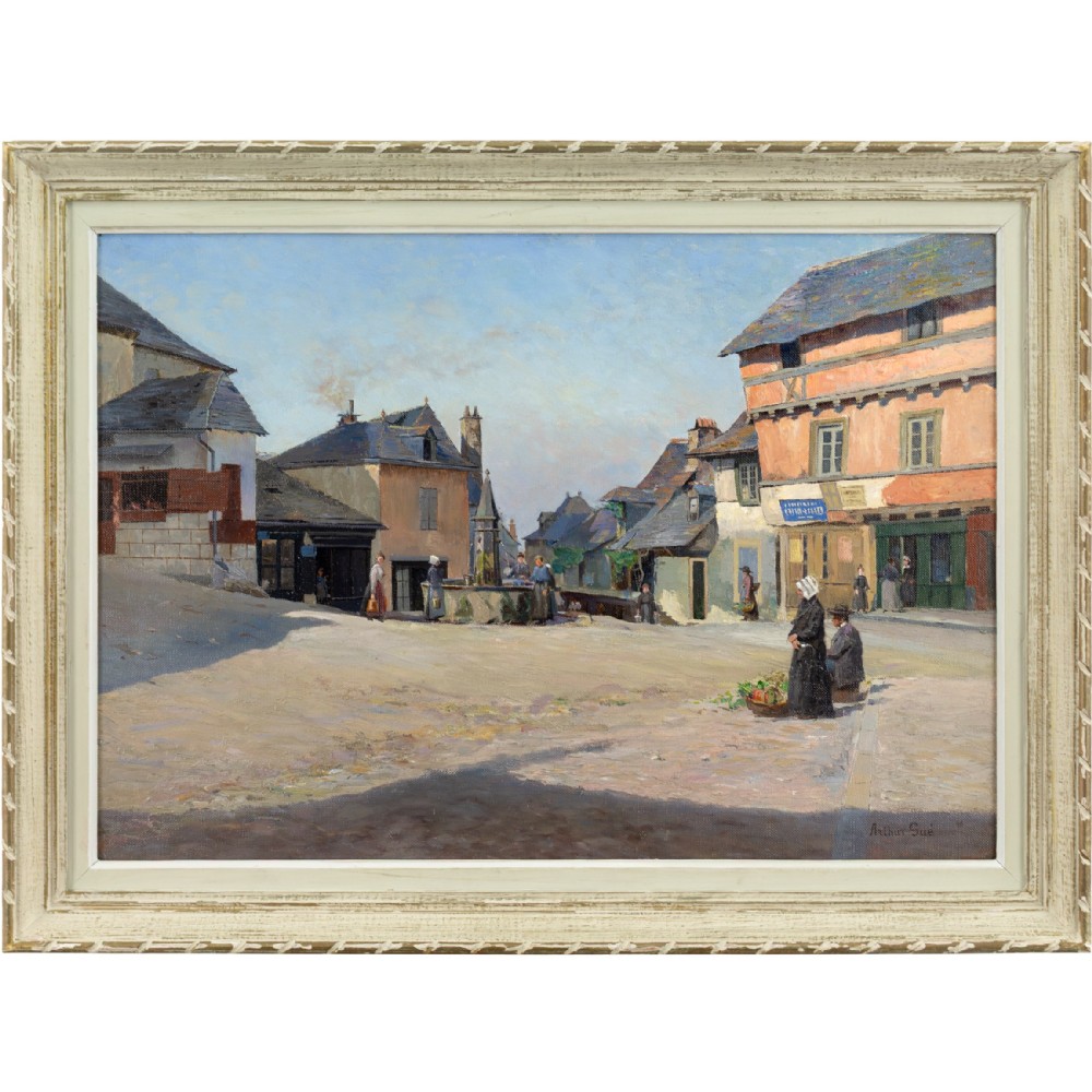 An antique oil painting depicting a sunlit French village square with townspeople, stone buildings, and a clear blue sky, housed in a light-coloured wooden frame.