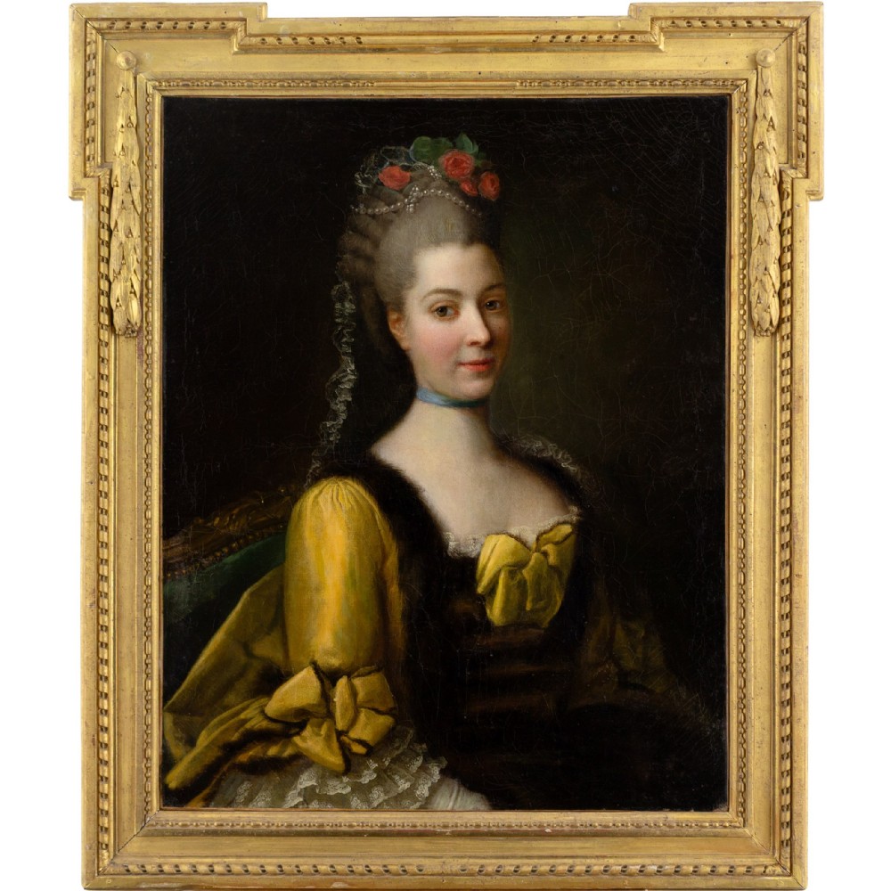 An eighteenth-century French oil painting on canvas depicting a lady with powdered hair and a yellow dress, housed in a carved gold leaf frame.
