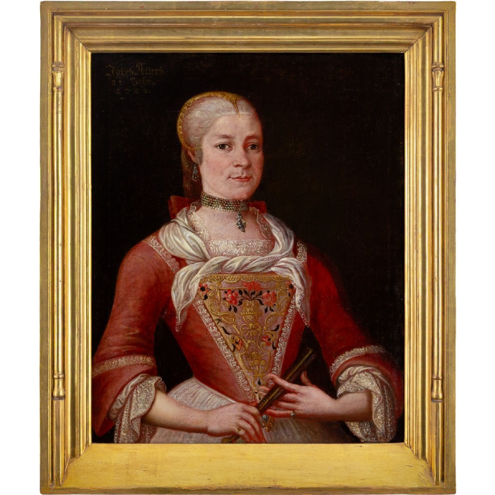 An 18th-century oil portrait depicting a woman in an embroidered red dress and gold headpiece set within a giltwood frame.