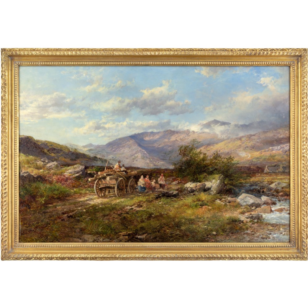 A 19th-century oil painting depicting travellers with a timber cart along a mountain trail beside a stream, set under a cloud-dappled blue sky within a giltwood frame.
