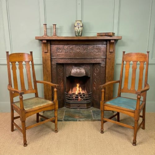 fig 1. A pair of high-backed Arts and Crafts oak armchairs with vertical back splats and studded leather seats.