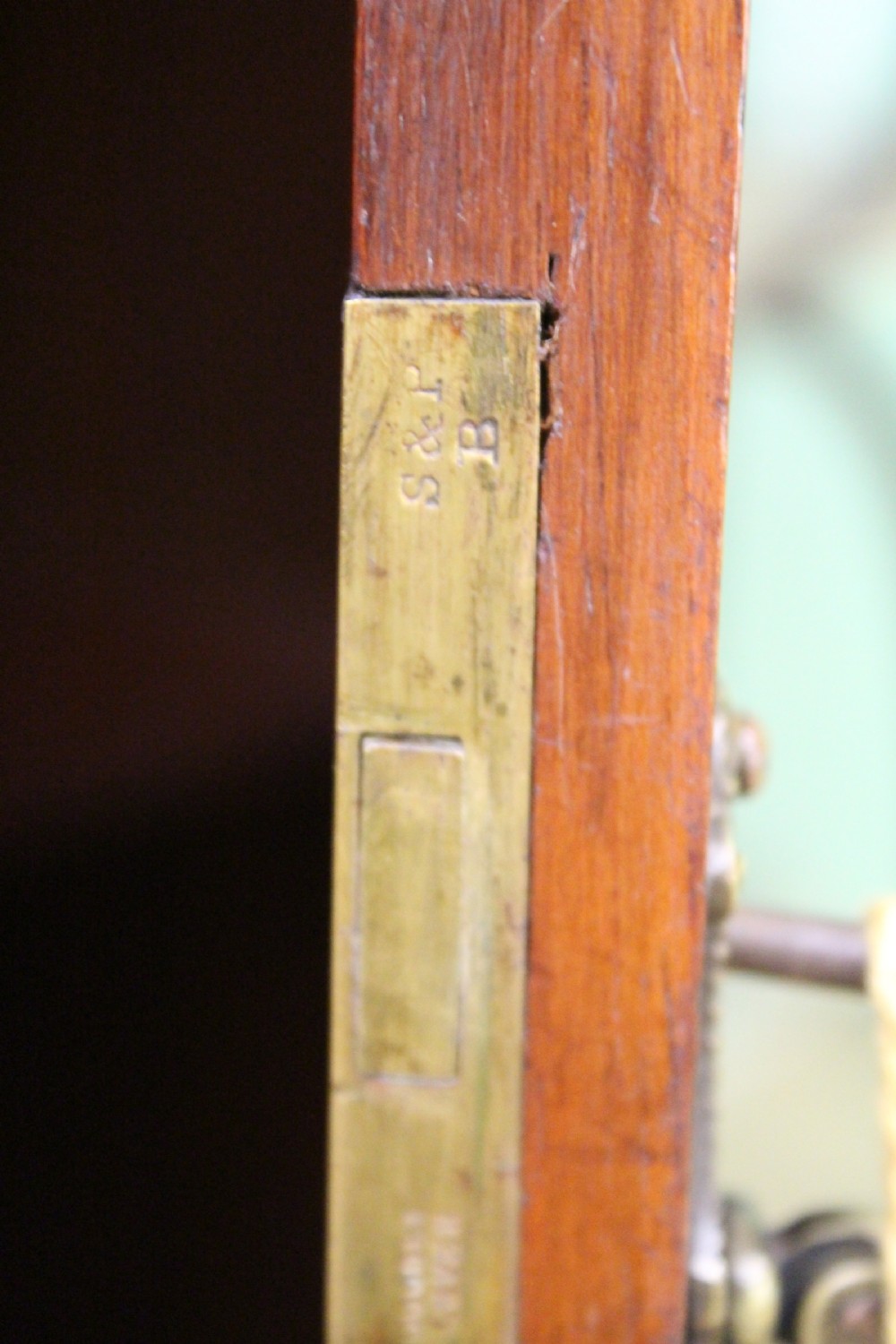An Edwardian inlaid mahogany side cabinet featuring two outer glazed display doors, a central wooden door with an oval inlay panel, and square tapered legs. View V