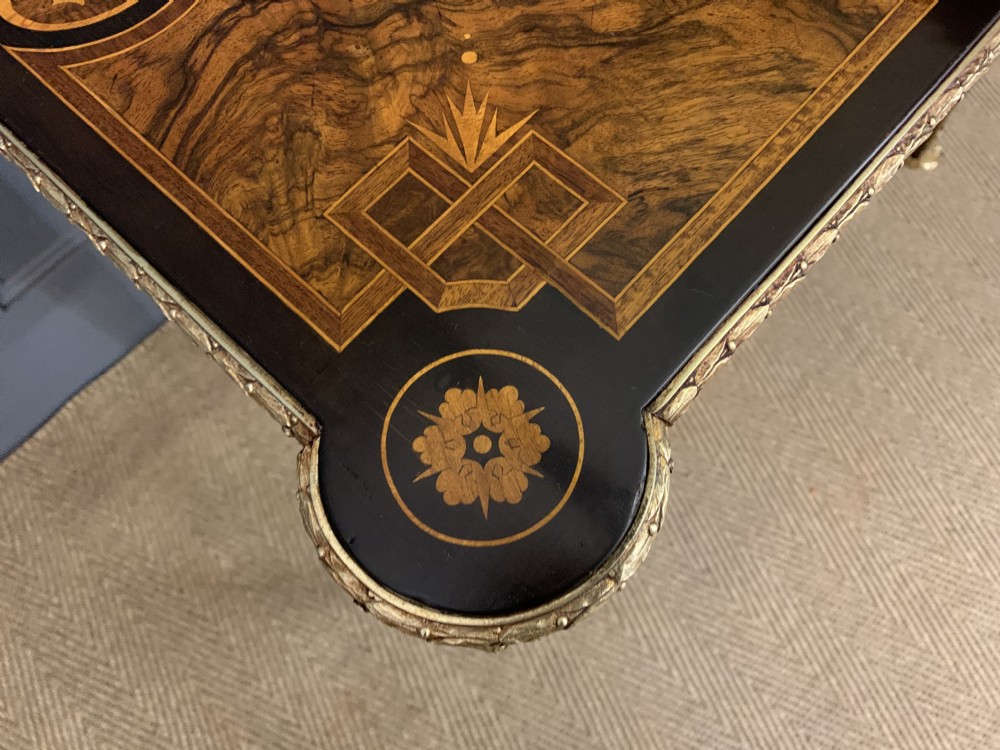 A 19th-century French burr walnut card table featuring intricate marquetry on the top, cabriole legs with gilt-bronze mounts, and a central porcelain plaque on the frieze. View IX