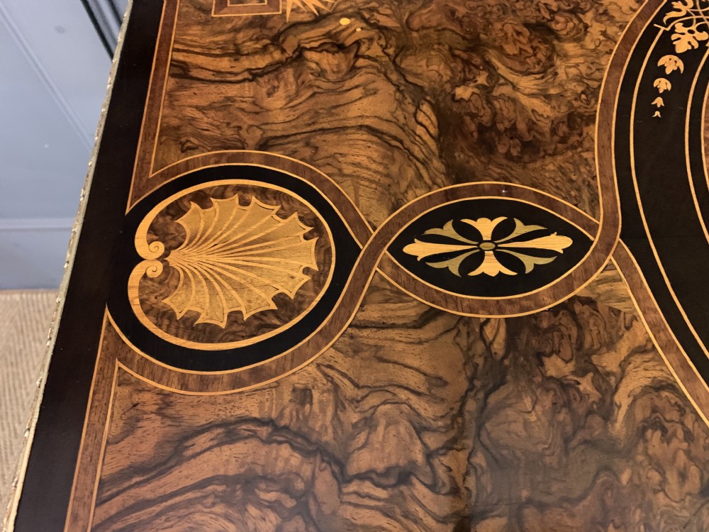 A 19th-century French burr walnut card table featuring intricate marquetry on the top, cabriole legs with gilt-bronze mounts, and a central porcelain plaque on the frieze. View X