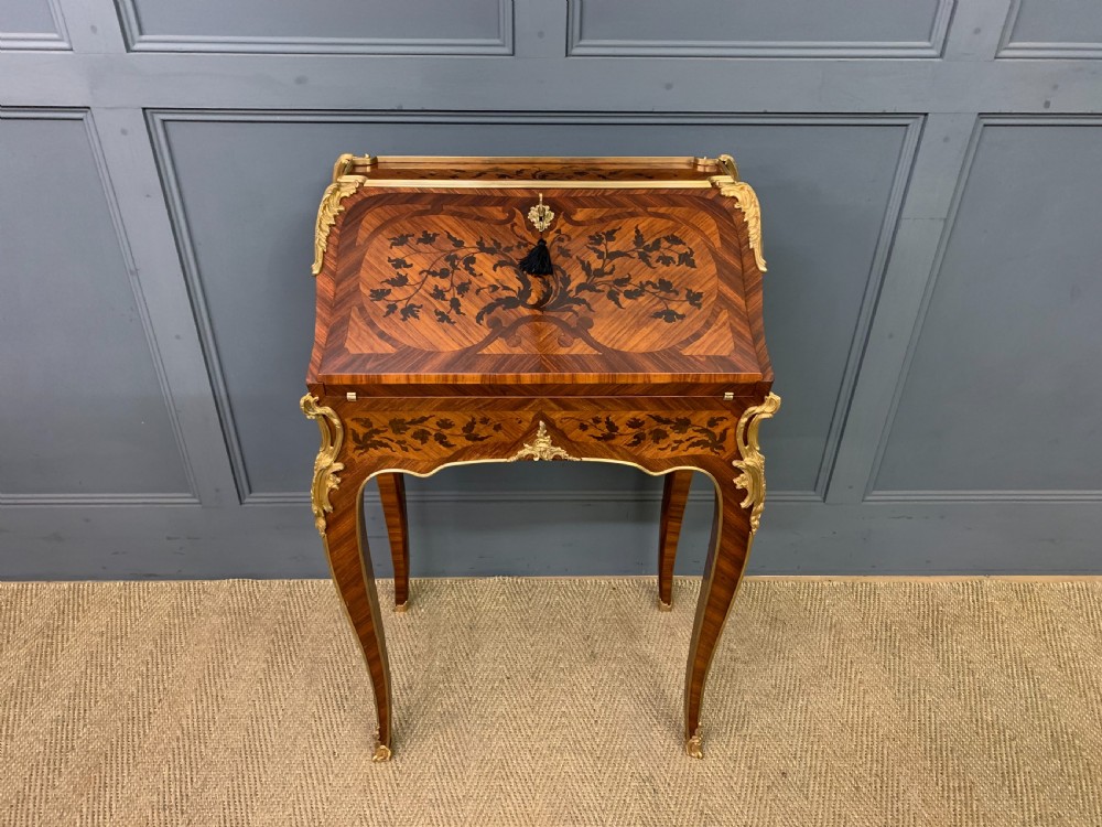 A French Louis XV style kingwood bureau de dame featuring floral marquetry inlays, gilt bronze ormolu mounts, slender cabriole legs, and a slant-front writing slope. View III