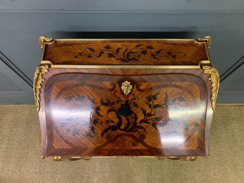 A French Louis XV style kingwood bureau de dame featuring floral marquetry inlays, gilt bronze ormolu mounts, slender cabriole legs, and a slant-front writing slope. View V