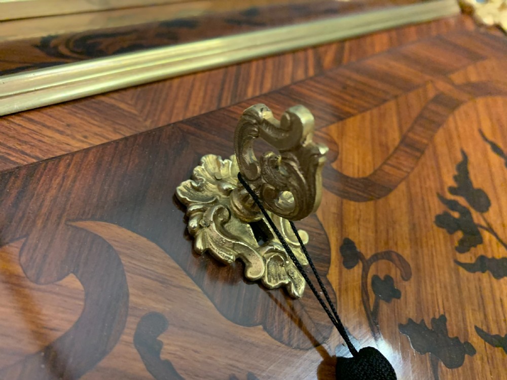 A French Louis XV style kingwood bureau de dame featuring floral marquetry inlays, gilt bronze ormolu mounts, slender cabriole legs, and a slant-front writing slope. View VI