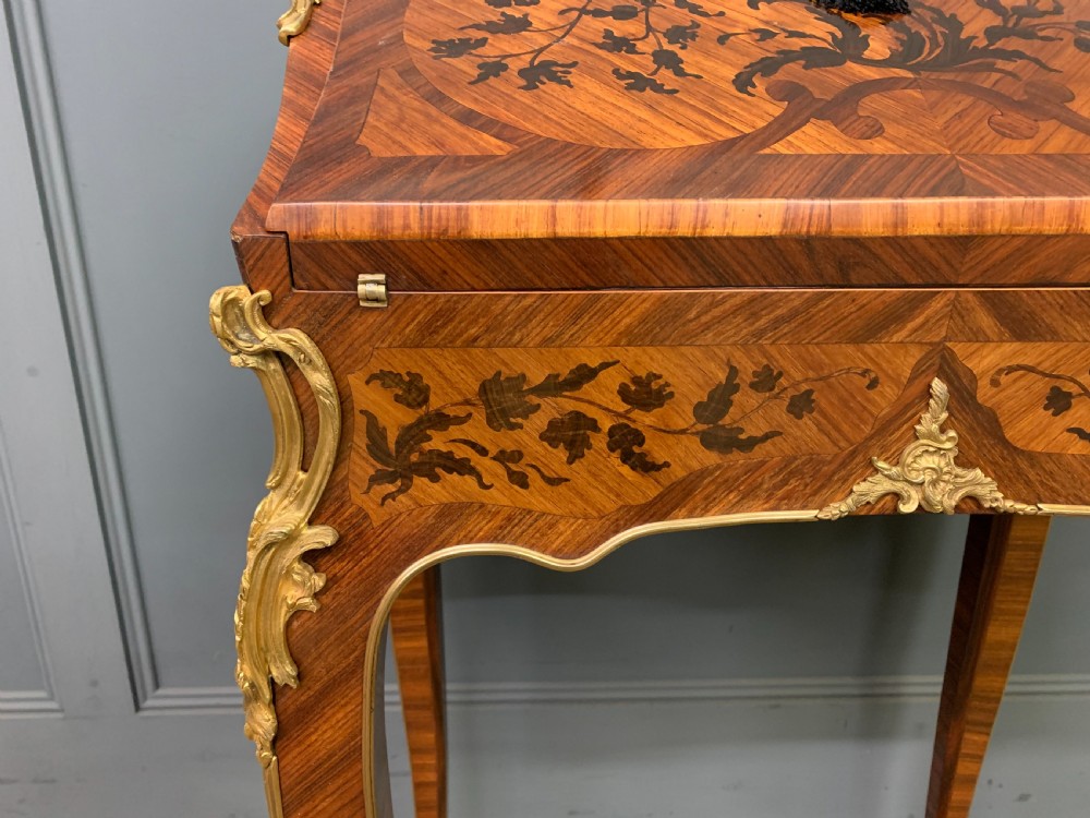 A French Louis XV style kingwood bureau de dame featuring floral marquetry inlays, gilt bronze ormolu mounts, slender cabriole legs, and a slant-front writing slope. View VII