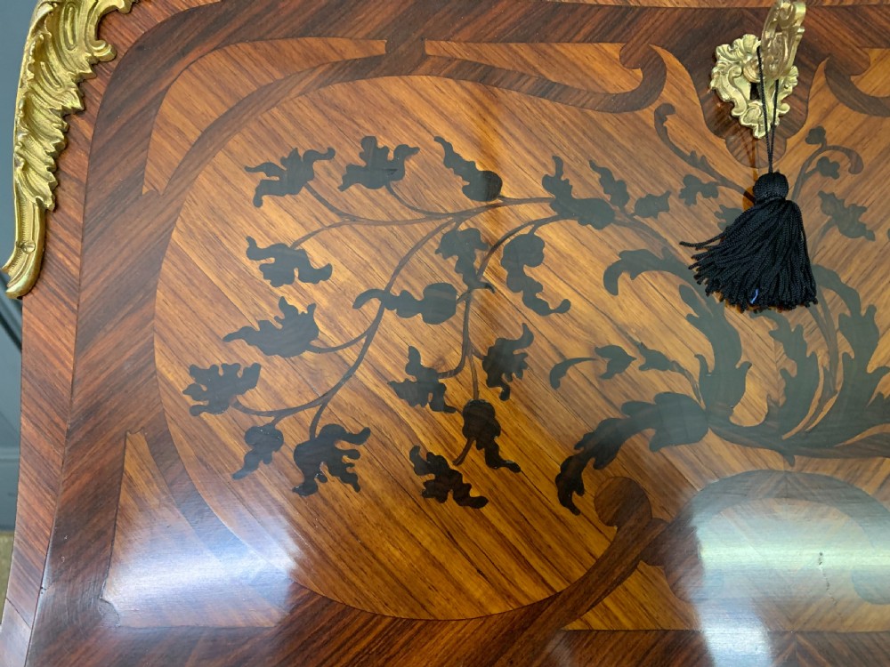 A French Louis XV style kingwood bureau de dame featuring floral marquetry inlays, gilt bronze ormolu mounts, slender cabriole legs, and a slant-front writing slope. View VIII