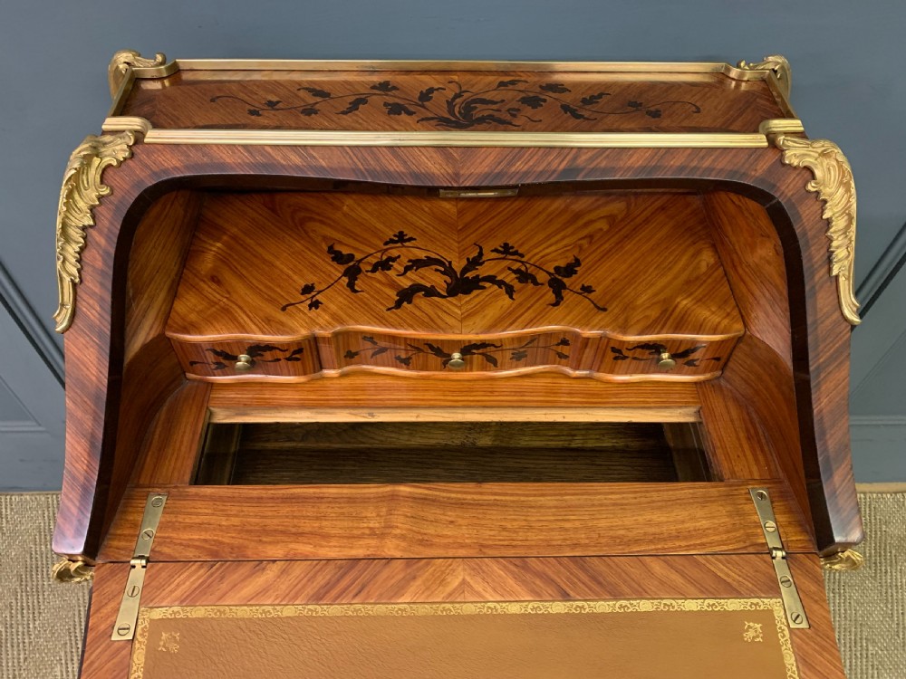 A French Louis XV style kingwood bureau de dame featuring floral marquetry inlays, gilt bronze ormolu mounts, slender cabriole legs, and a slant-front writing slope. View X