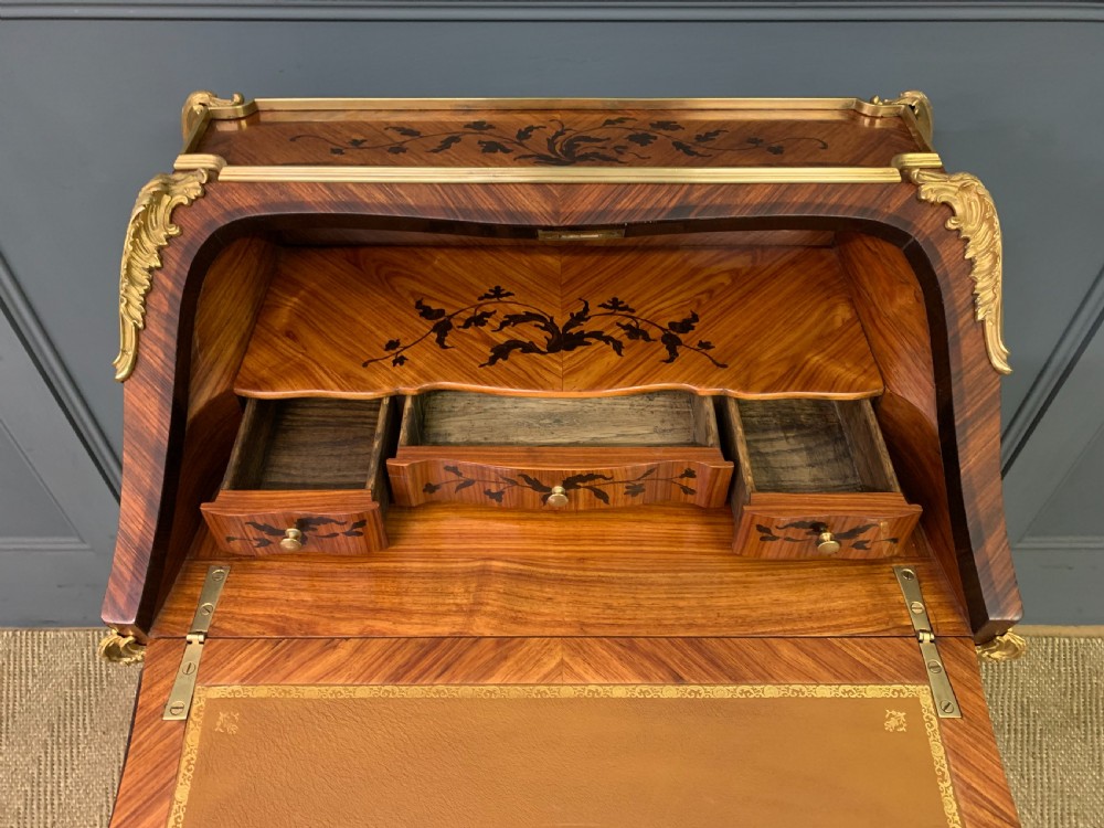 A French Louis XV style kingwood bureau de dame featuring floral marquetry inlays, gilt bronze ormolu mounts, slender cabriole legs, and a slant-front writing slope. View XI