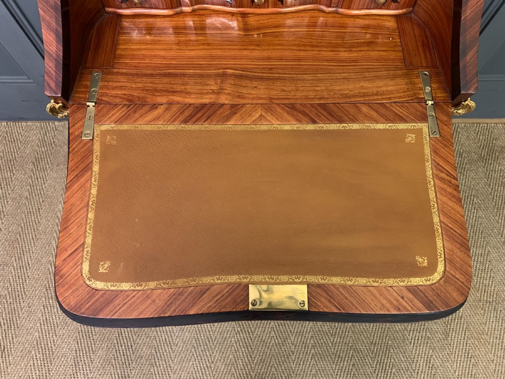 A French Louis XV style kingwood bureau de dame featuring floral marquetry inlays, gilt bronze ormolu mounts, slender cabriole legs, and a slant-front writing slope. View XII