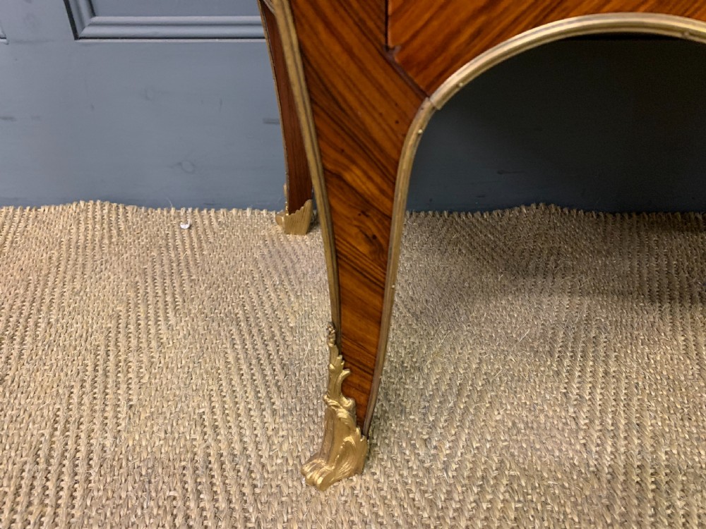 A 19th-century French kingwood vitrine cabinet with glass side panels, geometric parquetry lower door inlay, and ornate gilt-bronze ormolu mounts. View VII