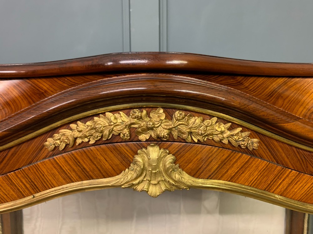 A 19th-century French kingwood vitrine cabinet with glass side panels, geometric parquetry lower door inlay, and ornate gilt-bronze ormolu mounts. View IX