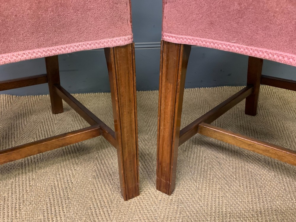 A pair of Georgian mahogany open armchairs with carved pierced splat backs and rose-coloured upholstered seats. View IV
