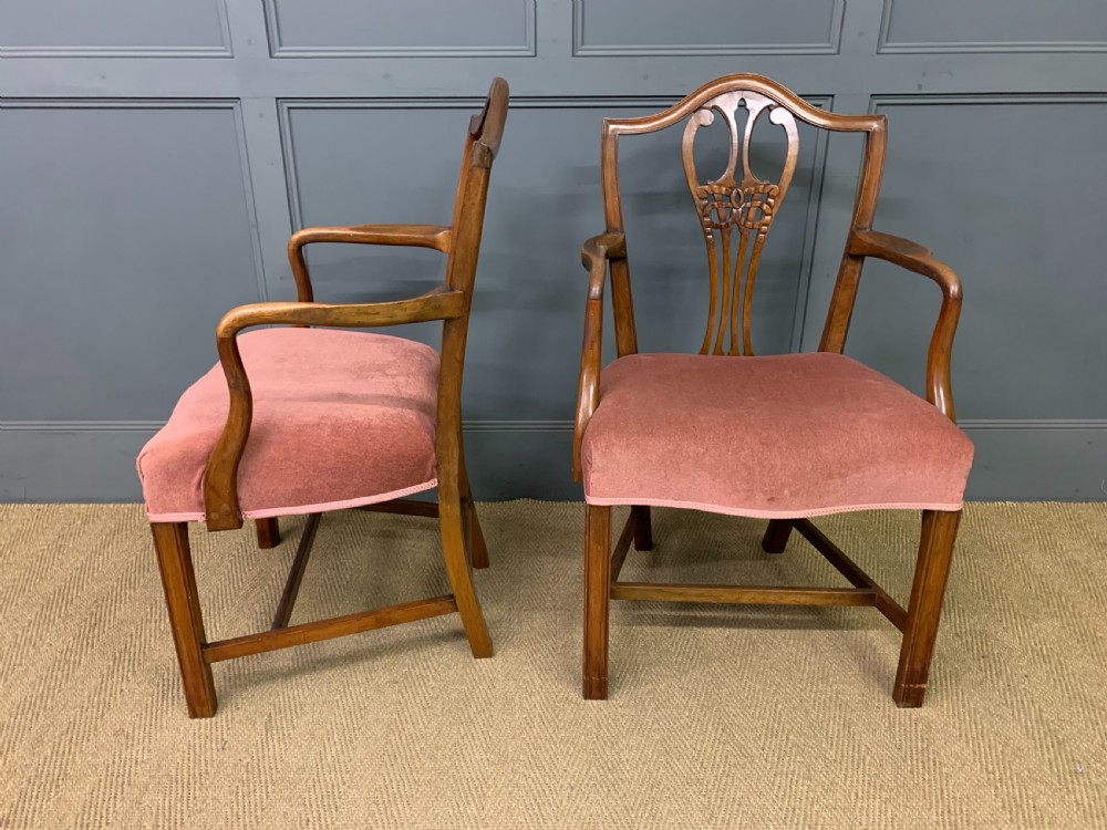 A pair of Georgian mahogany open armchairs with carved pierced splat backs and rose-coloured upholstered seats. View V