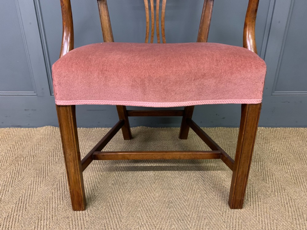 A pair of Georgian mahogany open armchairs with carved pierced splat backs and rose-coloured upholstered seats. View X