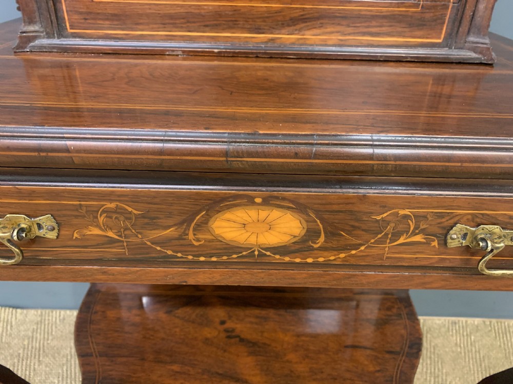 An antique inlaid rosewood bonheur du jour writing desk featuring a raised central cupboard with marquetry detail, single frieze drawer, and cabriole legs. View VI