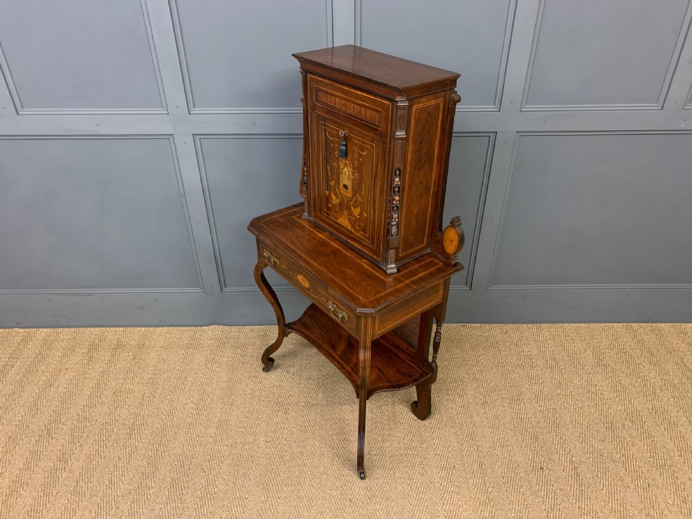 An antique inlaid rosewood bonheur du jour writing desk featuring a raised central cupboard with marquetry detail, single frieze drawer, and cabriole legs. View XVI