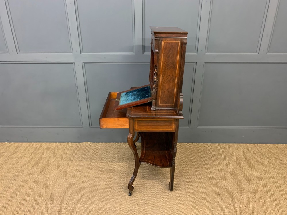An antique inlaid rosewood bonheur du jour writing desk featuring a raised central cupboard with marquetry detail, single frieze drawer, and cabriole legs. View XVII