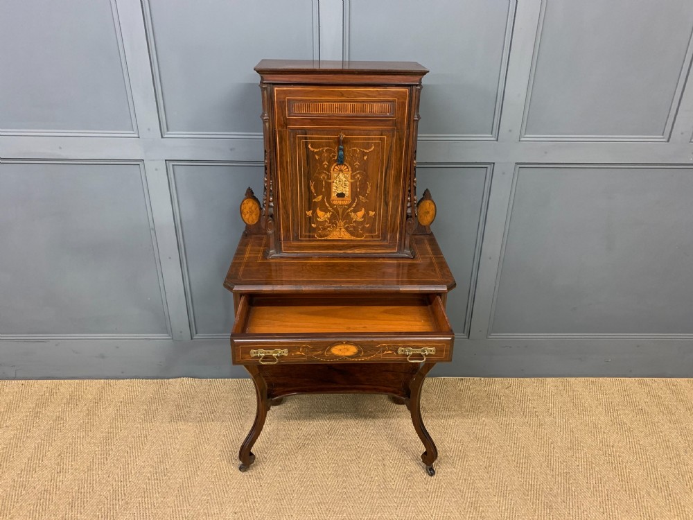 An antique inlaid rosewood bonheur du jour writing desk featuring a raised central cupboard with marquetry detail, single frieze drawer, and cabriole legs. View XIX